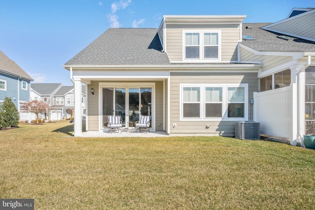 back of property featuring cooling unit, a lawn, and a patio area