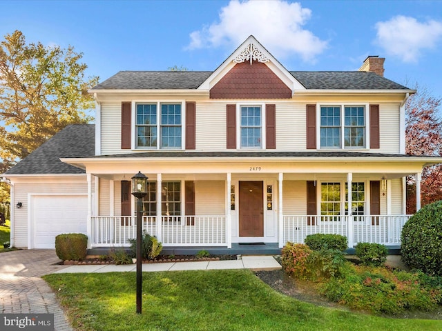 view of front of property with a porch and a garage