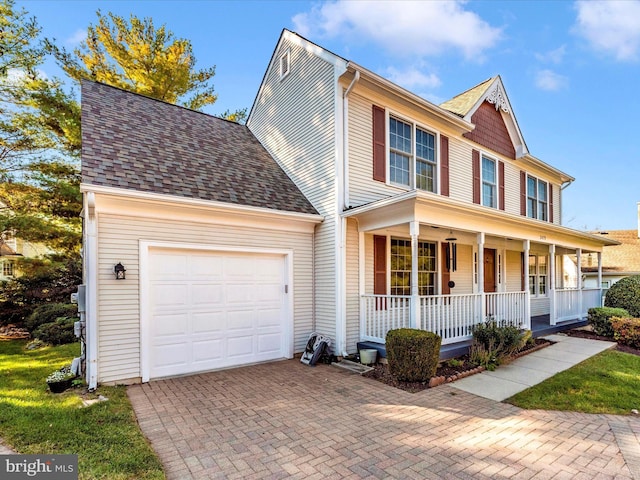 view of front facade featuring covered porch and a garage