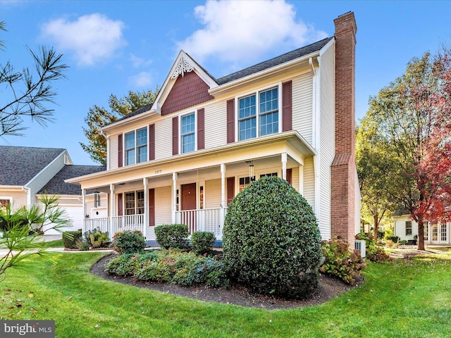 view of front of home featuring a front yard and a porch