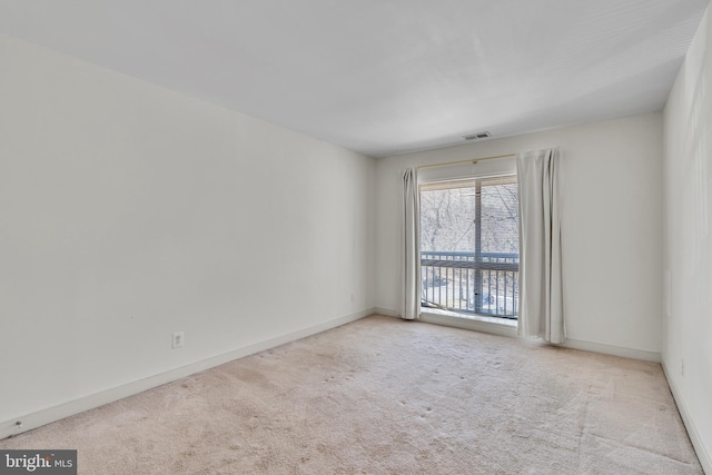 carpeted empty room with visible vents and baseboards