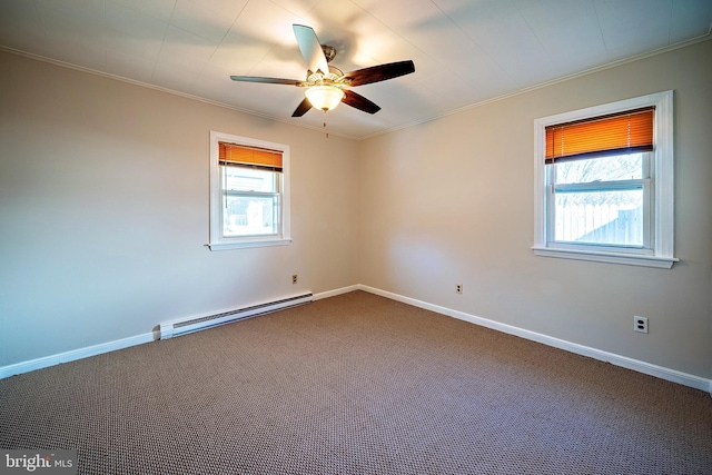 empty room with crown molding, a wealth of natural light, and baseboard heating