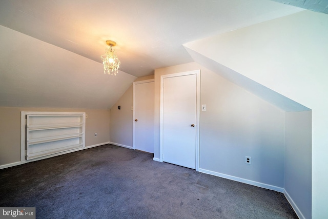 additional living space featuring baseboards, built in shelves, carpet flooring, and vaulted ceiling