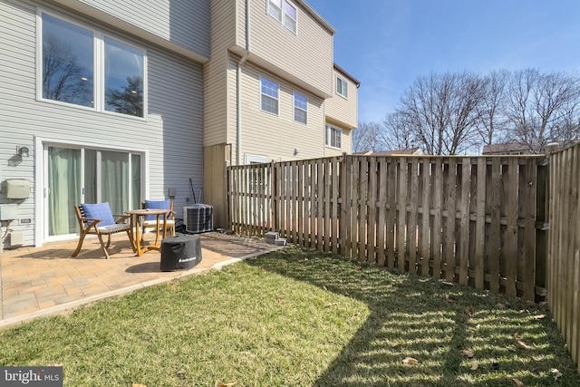 view of yard featuring cooling unit, a patio, and a fenced backyard