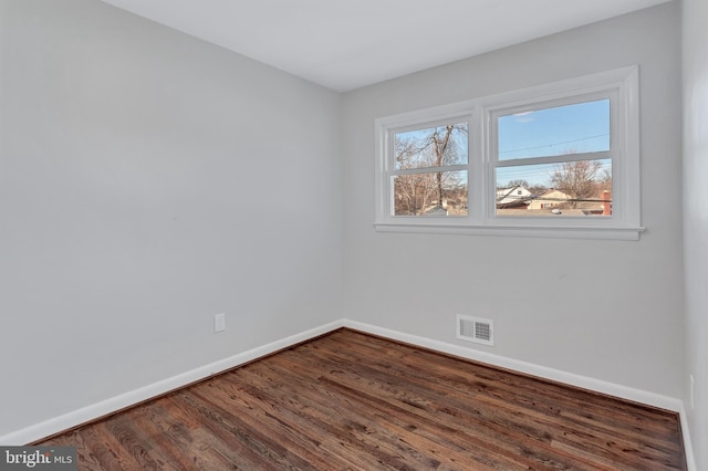 spare room with dark wood-type flooring