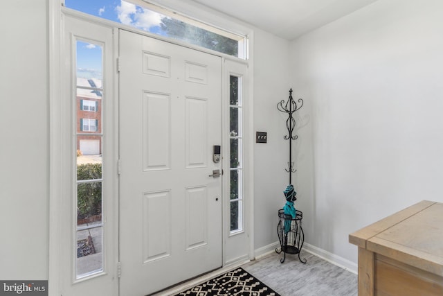 entrance foyer with light wood finished floors and baseboards