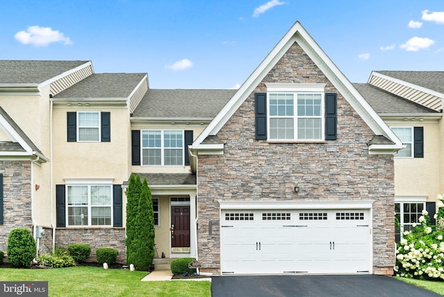 view of front of house featuring a garage, roof with shingles, driveway, and stucco siding