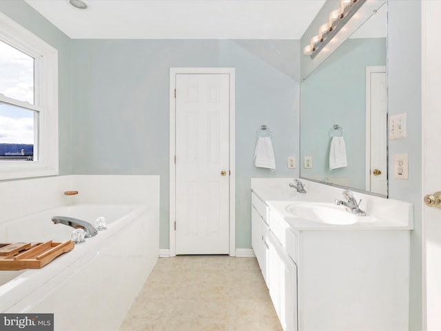 bathroom featuring a bath, double vanity, baseboards, and a sink