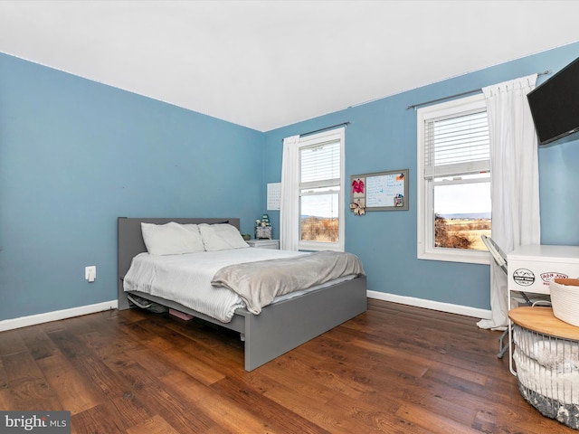 bedroom featuring baseboards and wood finished floors