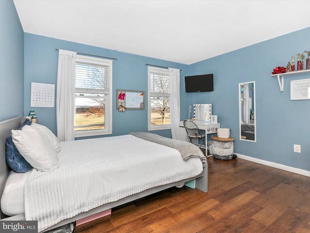 bedroom featuring baseboards and wood finished floors