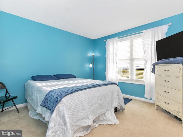 bedroom with carpet and baseboards