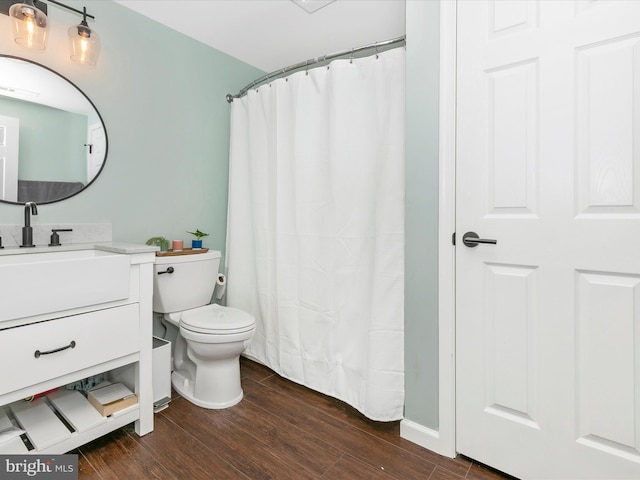 full bath featuring toilet, wood finished floors, and vanity