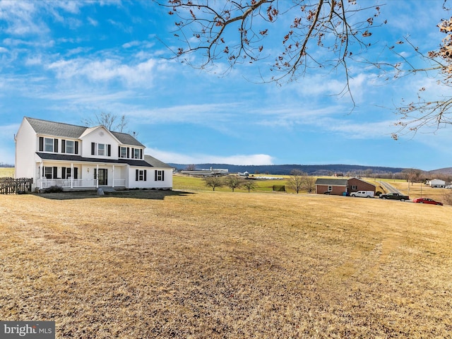 exterior space with covered porch and a front lawn