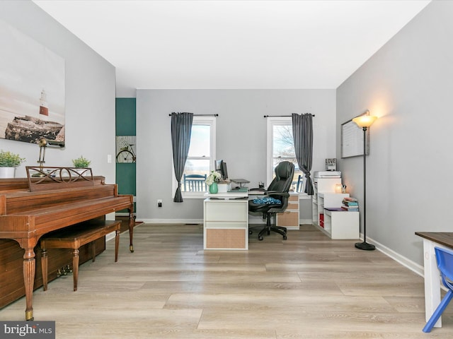 office area with light wood-style flooring and baseboards