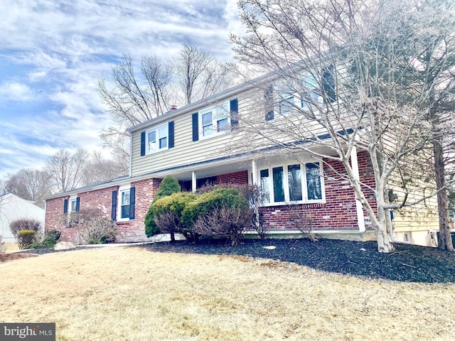 traditional-style home with brick siding