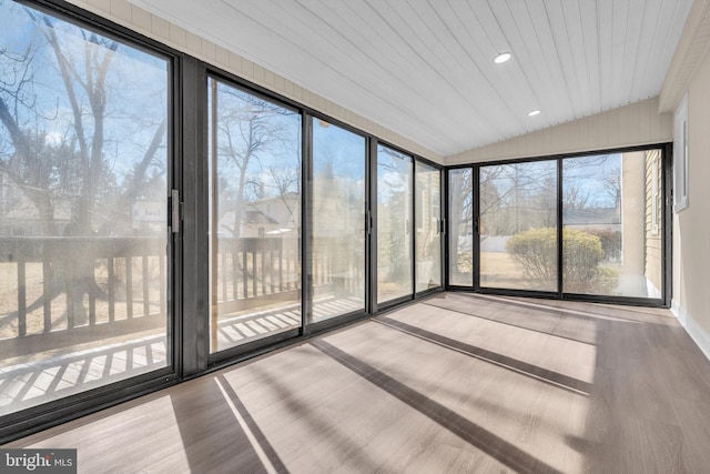 unfurnished sunroom featuring vaulted ceiling