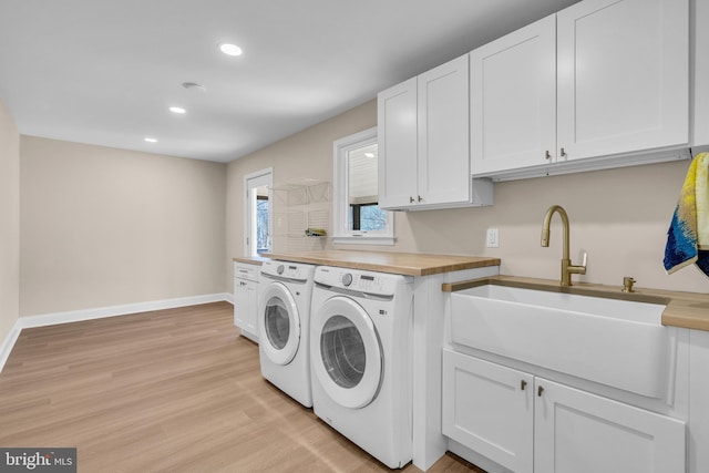 washroom featuring recessed lighting, a sink, baseboards, light wood-style floors, and washing machine and clothes dryer