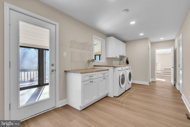 kitchen featuring light wood-style floors, white cabinets, baseboards, and separate washer and dryer