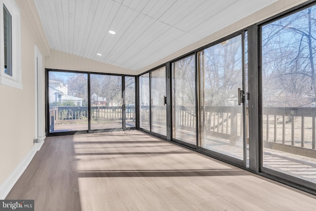 unfurnished sunroom with lofted ceiling and wooden ceiling