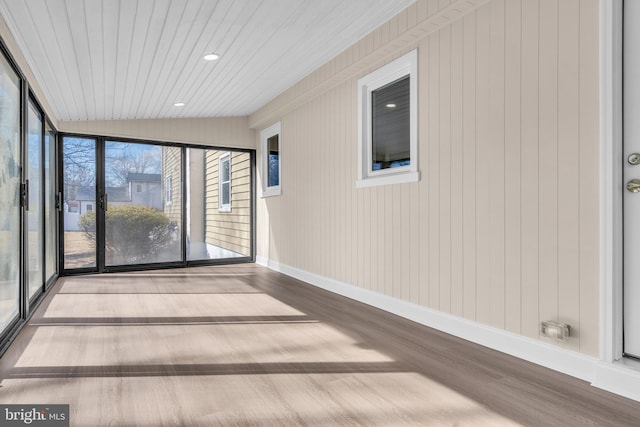 unfurnished sunroom featuring vaulted ceiling