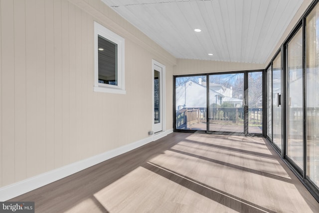 unfurnished sunroom featuring lofted ceiling