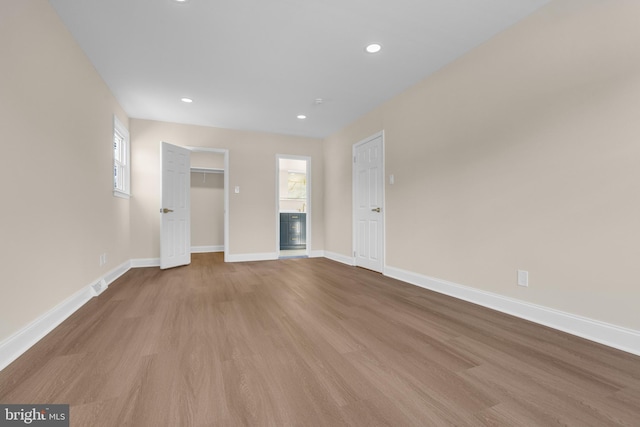 interior space with recessed lighting, visible vents, baseboards, and wood finished floors