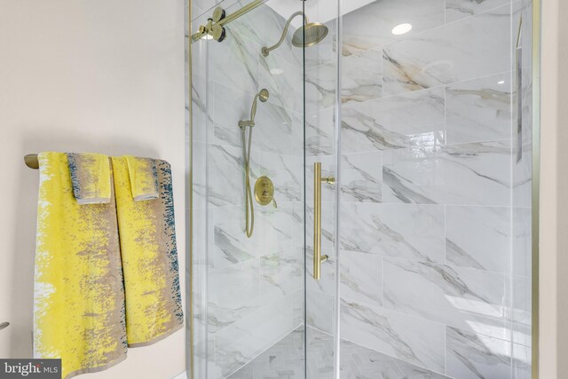 bathroom with a marble finish shower