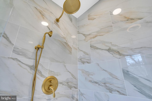 details featuring a marble finish shower