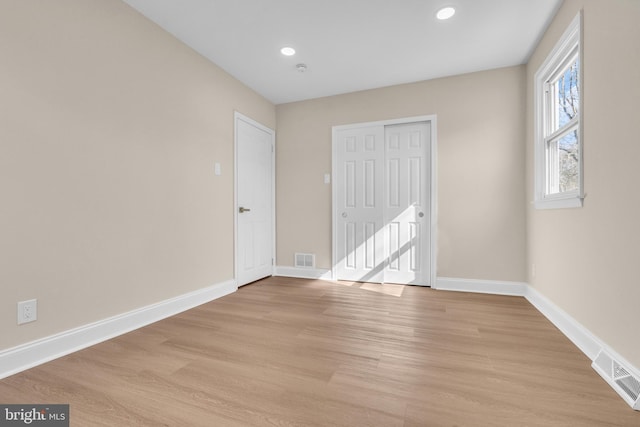 unfurnished bedroom with light wood finished floors, recessed lighting, visible vents, and baseboards