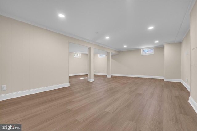 below grade area featuring light wood-type flooring, baseboards, and recessed lighting