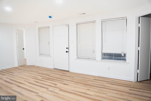 interior space with light wood-style flooring and baseboards