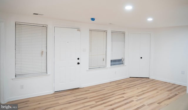 interior space featuring recessed lighting, light wood-style flooring, and baseboards