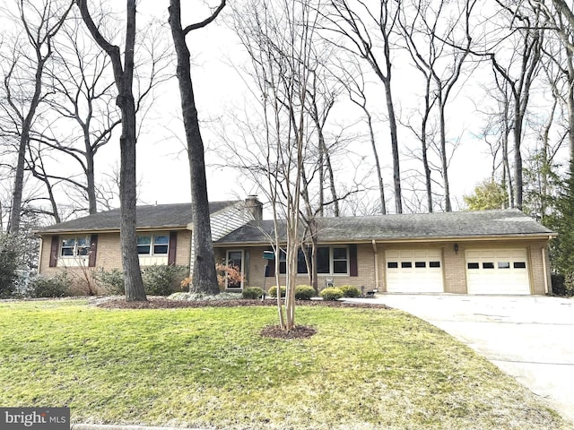 view of front facade with brick siding, concrete driveway, a front lawn, and a garage