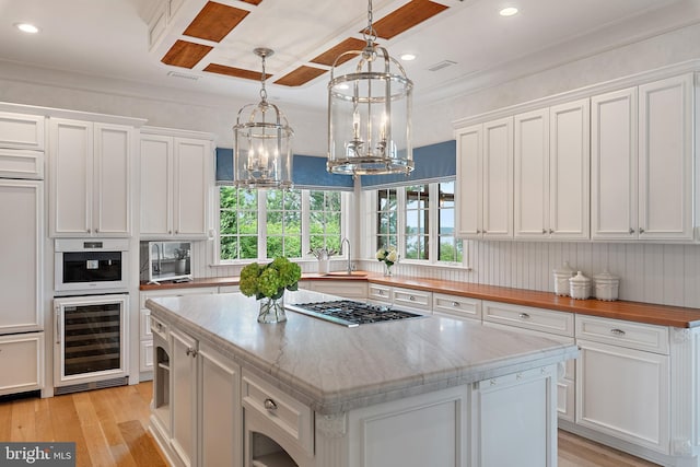 1556 Widows Mite Rd, Edgewater, MD 21037 - kitchen with stainless steel gas cooktop, beverage cooler, a chandelier, white cabinetry, and recessed lighting