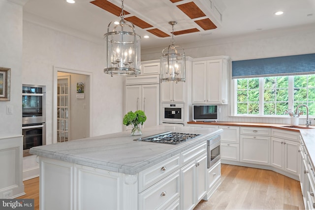 1556 Widows Mite Rd, Edgewater, MD 21037 - kitchen featuring built in appliances, white cabinets, light wood-style flooring, a center island, and a chandelier
