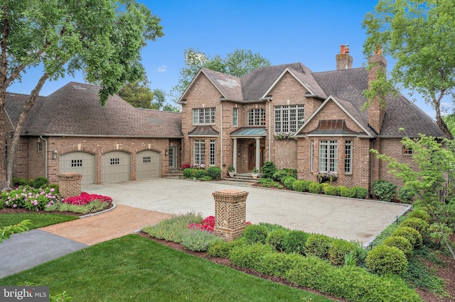 1556 Widows Mite Rd, Edgewater, MD 21037 - colonial house with a garage, brick siding, a shingled roof, a chimney, and driveway