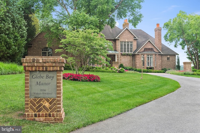 1556 Widows Mite Rd, Edgewater, MD 21037 - view of front of property featuring a front yard, brick siding, and a chimney