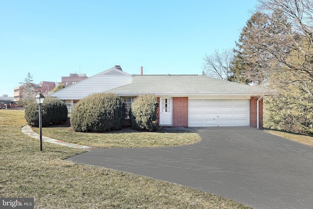 ranch-style home with a front yard and a garage