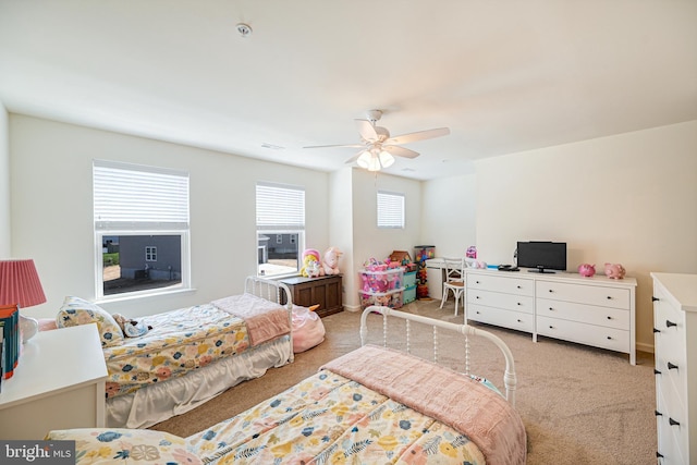 bedroom featuring light carpet and ceiling fan