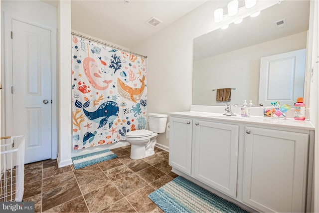 bathroom featuring toilet, visible vents, a shower with shower curtain, and vanity