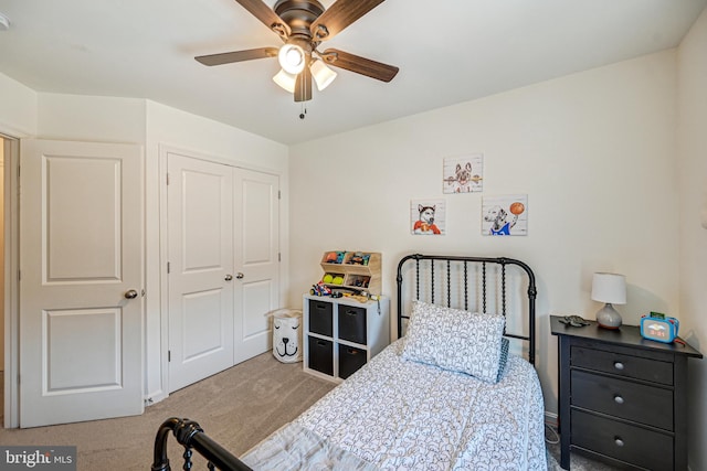 bedroom featuring ceiling fan, a closet, and carpet flooring