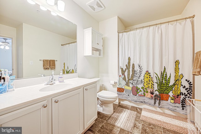 bathroom with visible vents, toilet, a shower with curtain, ceiling fan, and vanity