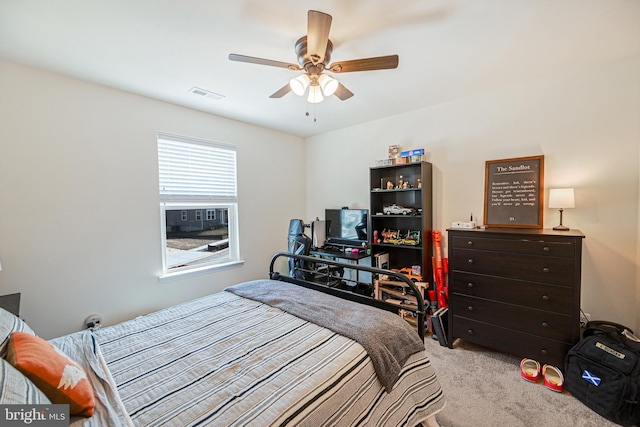 carpeted bedroom with ceiling fan and visible vents