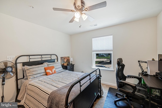 carpeted bedroom featuring ceiling fan and baseboards