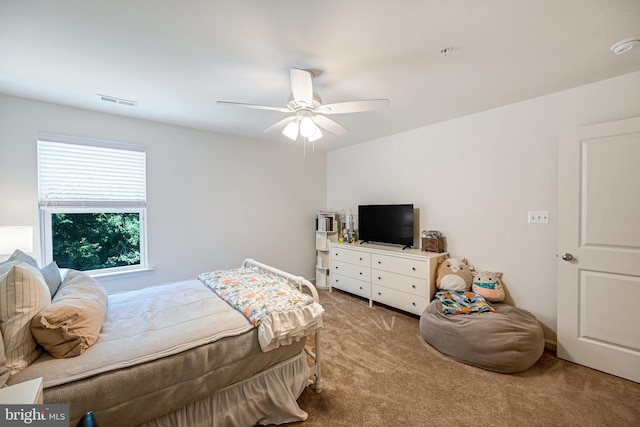 carpeted bedroom with ceiling fan and visible vents