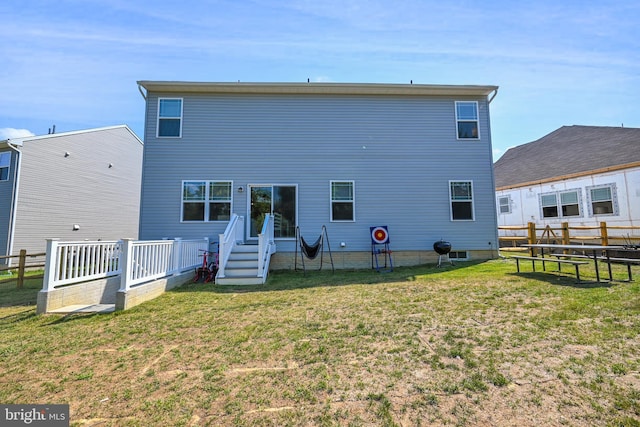 back of property with a yard and fence