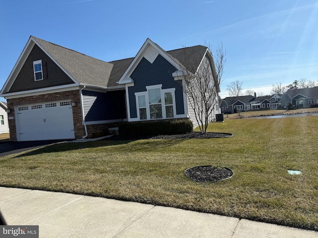 view of front of house with a front lawn, driveway, and a garage