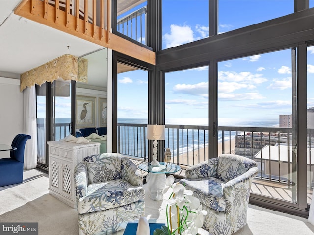 sunroom / solarium featuring a water view and a healthy amount of sunlight