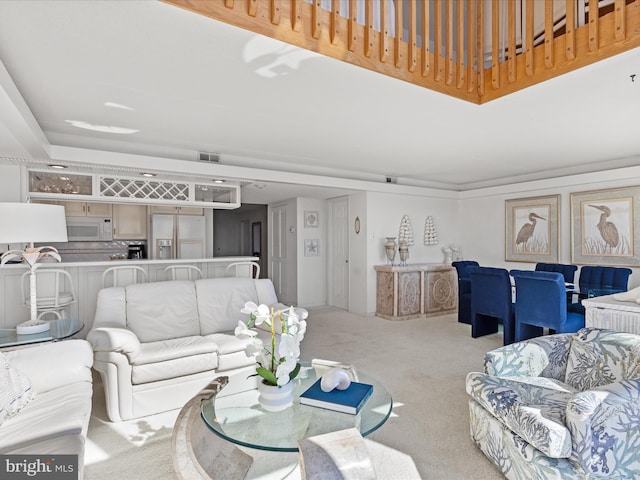 living room featuring visible vents and light colored carpet