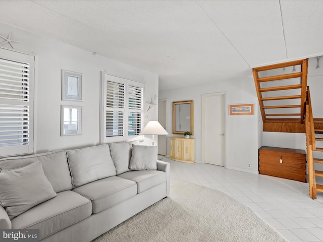 carpeted living area featuring tile patterned flooring